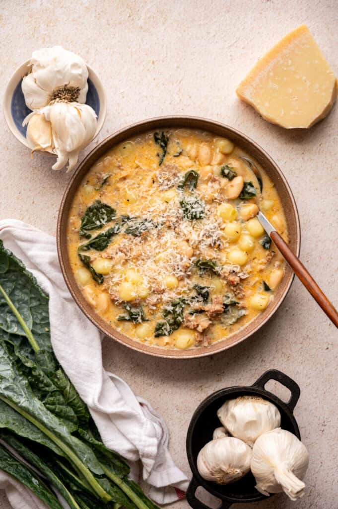 Kale and White Bean Sausage Soup in a bowl with a spoon.