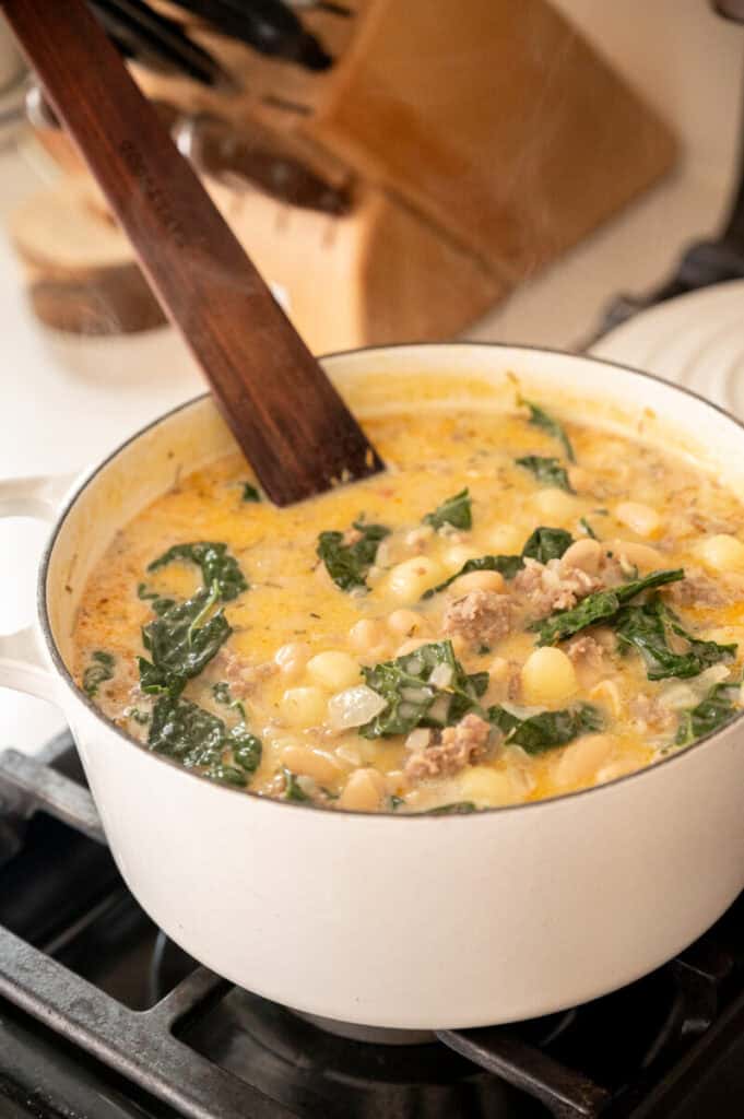 Kale and White Bean Sausage Soup in a pot.