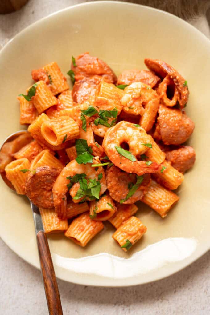 Creamy Shrimp and Sausage Pasta Recipe on a plate with a spoon.
