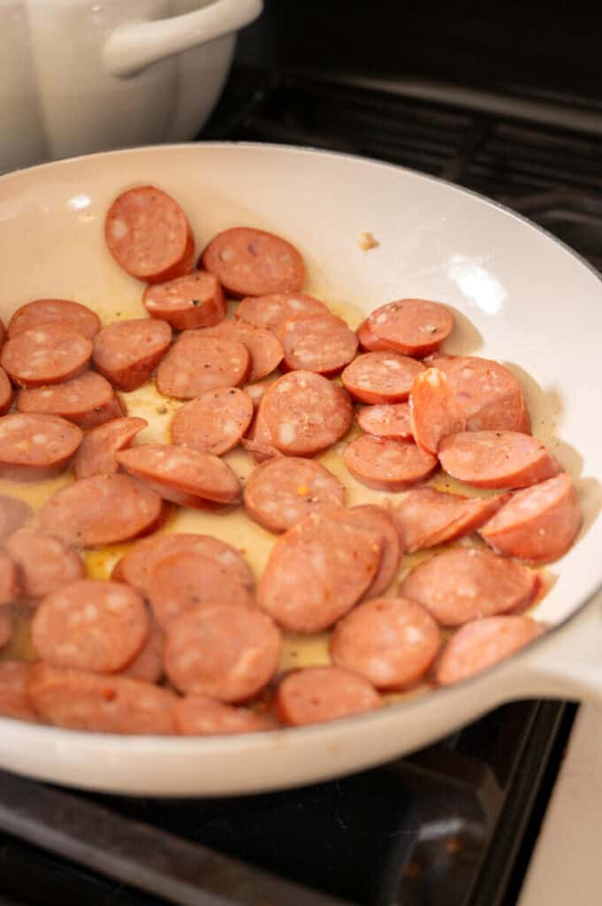 sausage cooking in a pan.