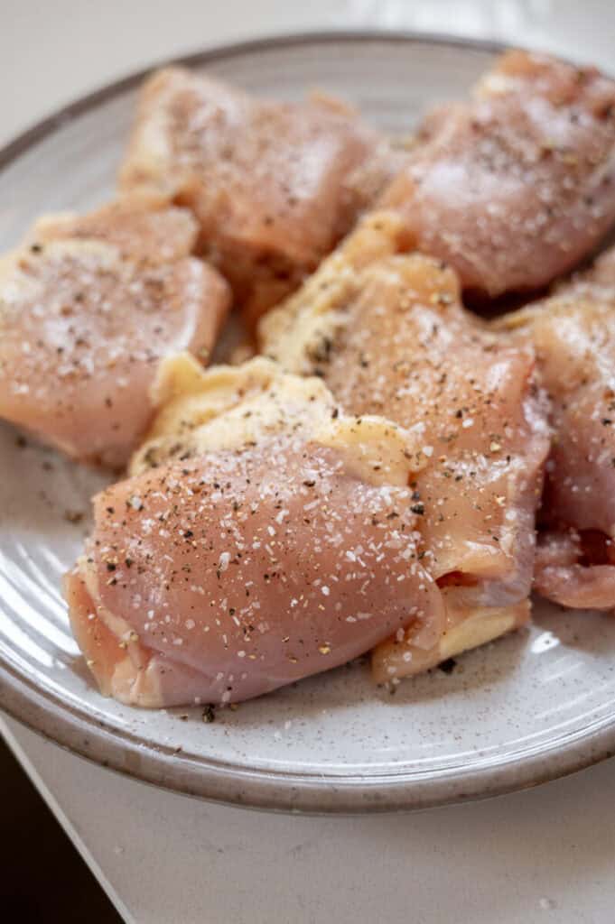 chicken thighs seasoned with salt and pepper.