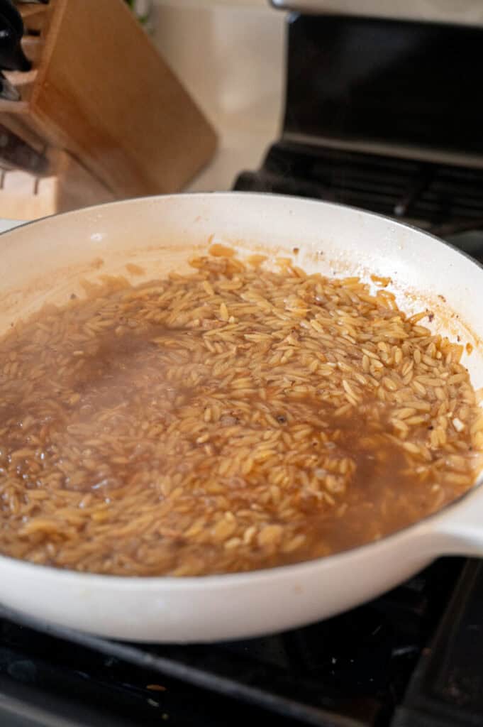 orzo cooking in chicken broth.