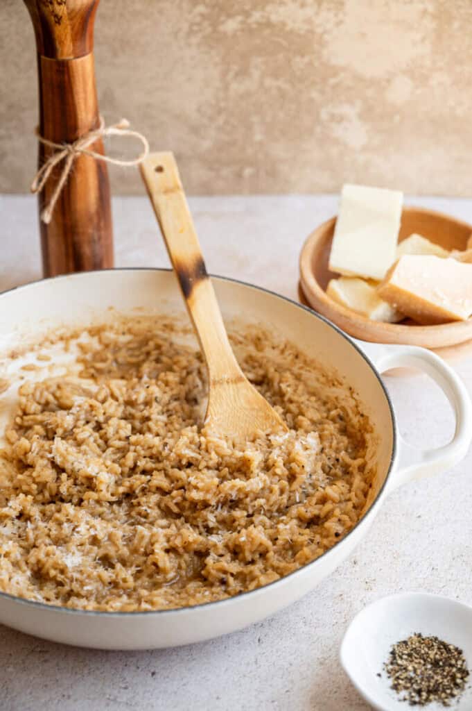 cacio e pepe risotto in a large pan.