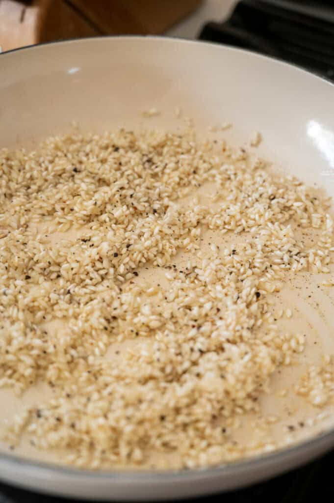 rice and pepper toasting in a pan.