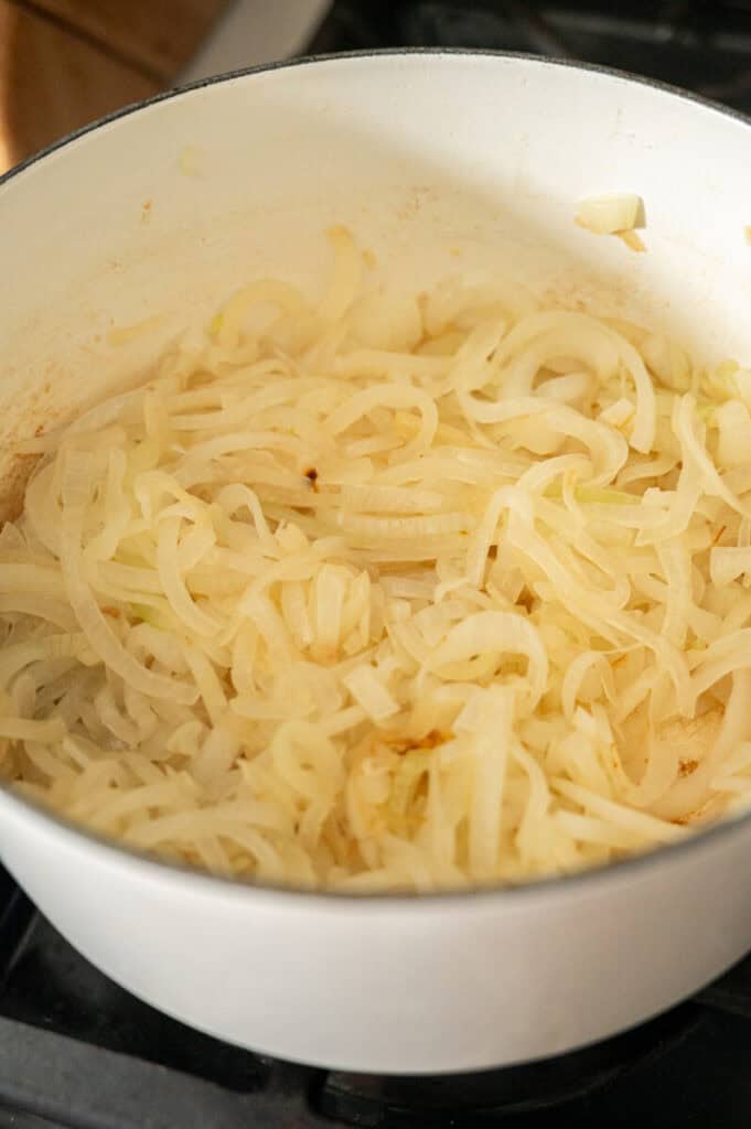 onions cooking in a pot.