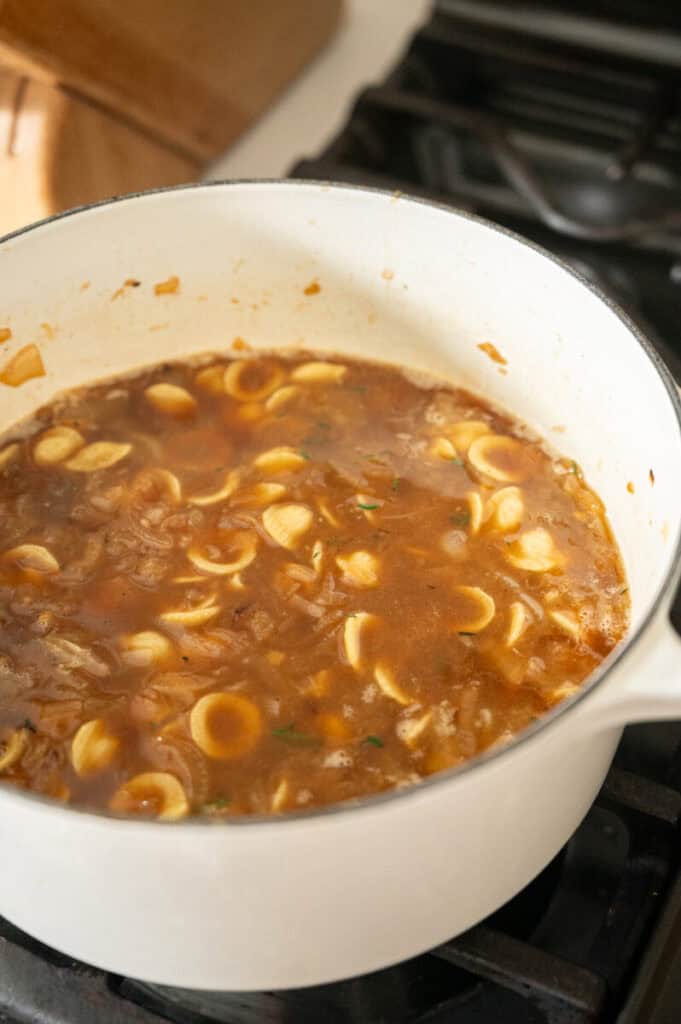 pasta cooking in beef broth.