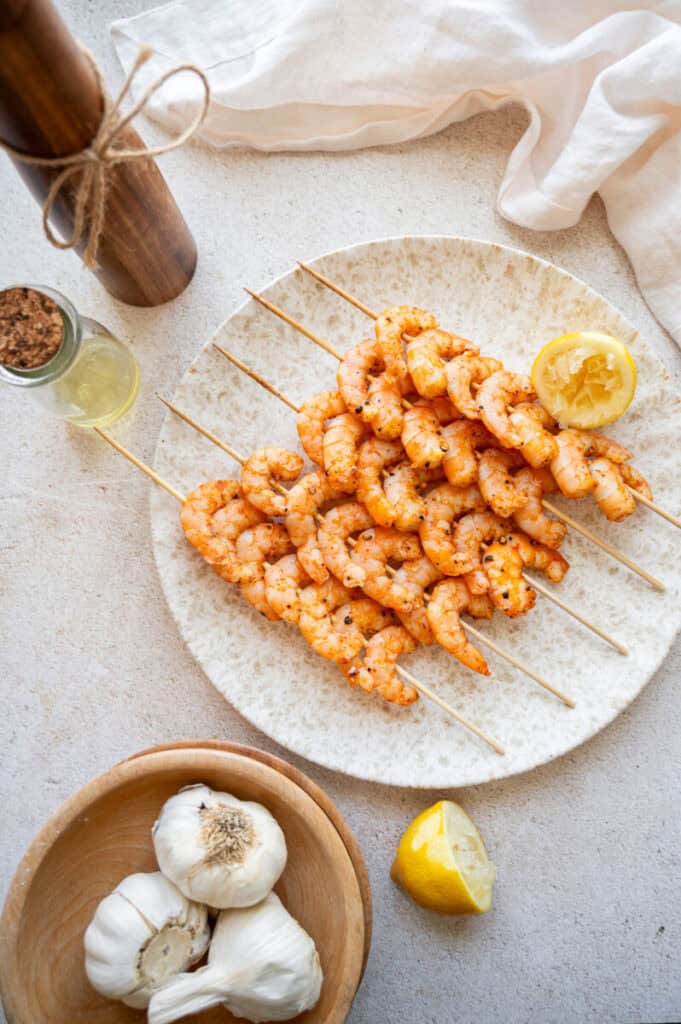 oven shrimp skewers on a plate.