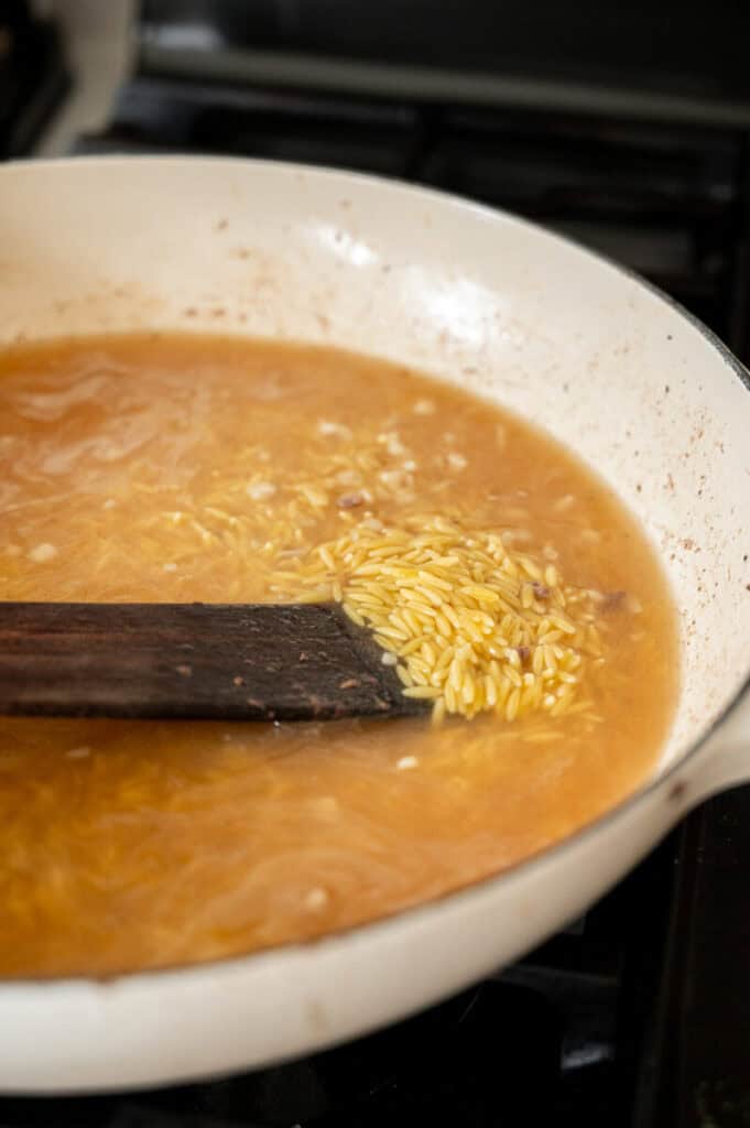 orzo cooking in chicken broth.