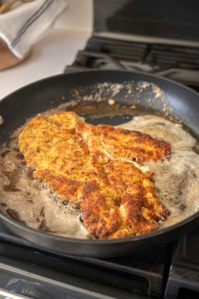 chicken frying in a pan.