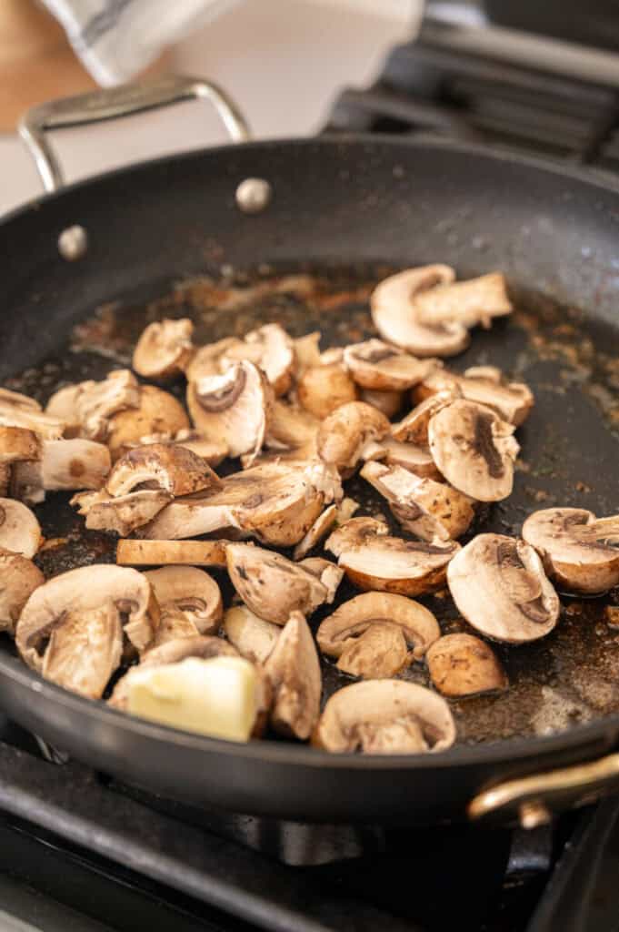 mushrooms sautéing in a pan.