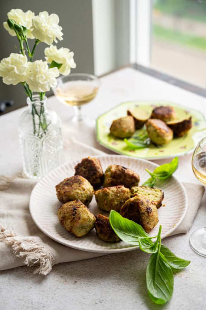 pesto chicken meatballs with fresh basil.