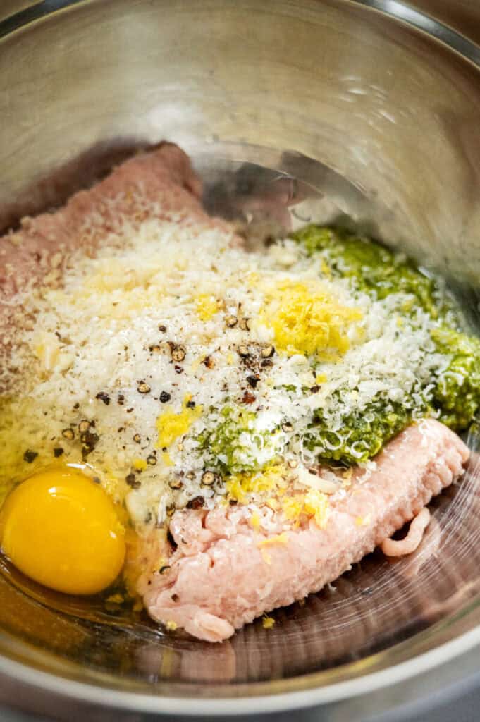 pesto chicken meatballs ingredients in a bowl.