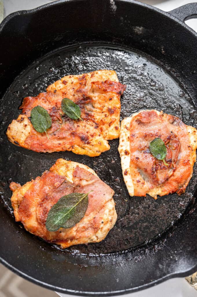 chicken saltimbocca in a cast iron pan.