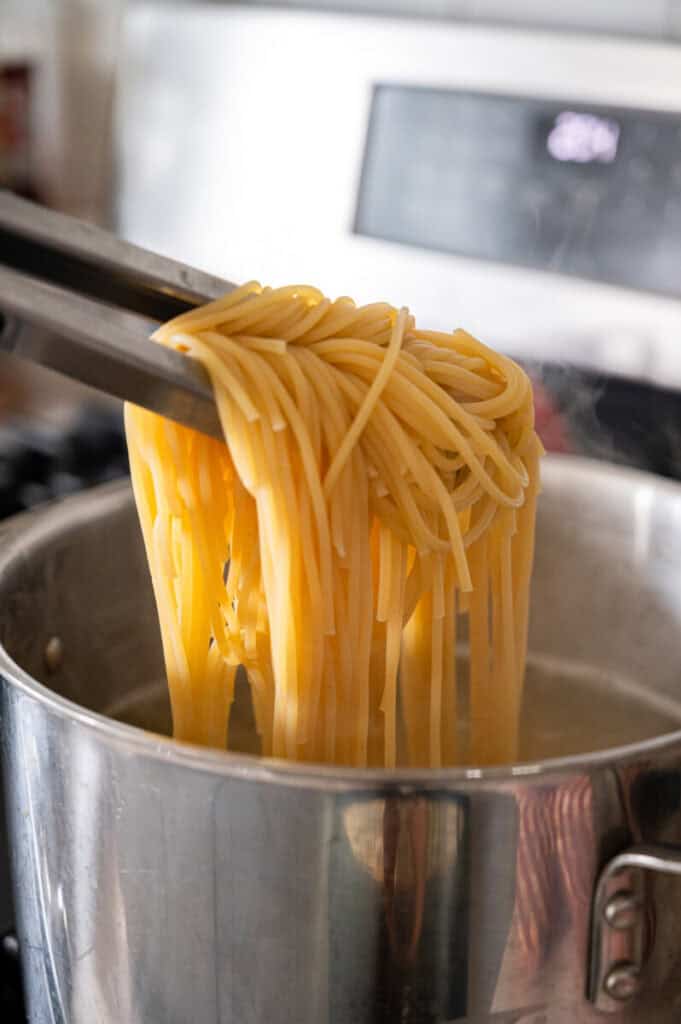 spaghetti cooking in a pot.