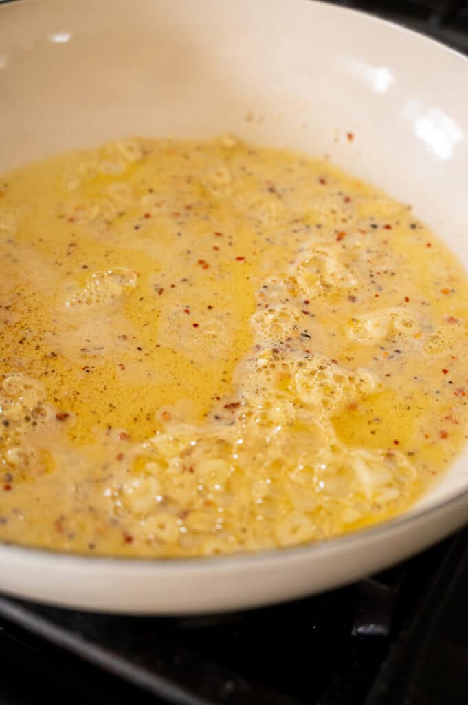 olive oil, butter, and white wine sauce in a skillet.