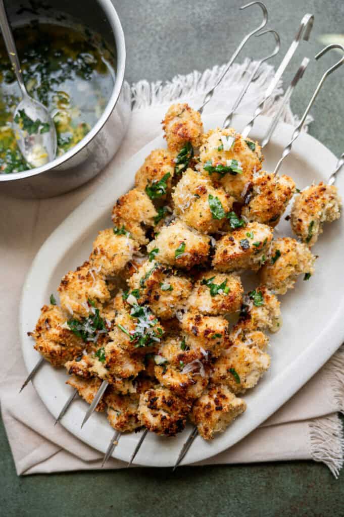 chicken spiedini on skewers with amoigo sauce.