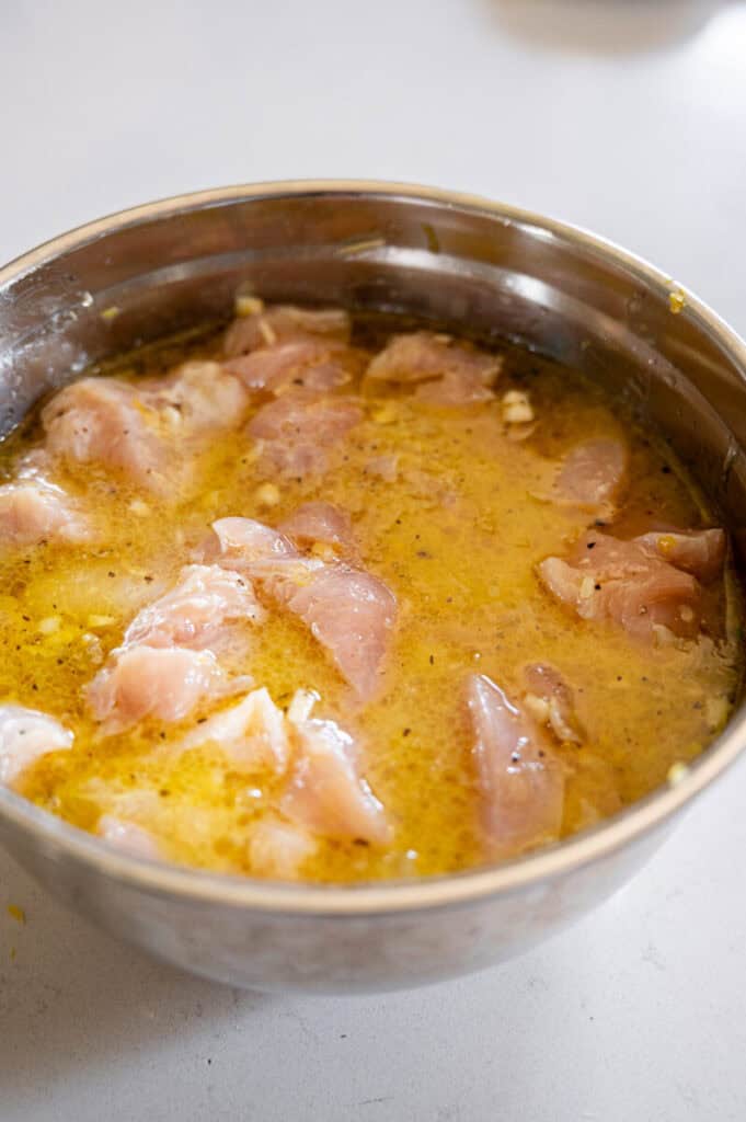 chicken marinating in white wine and lemon.