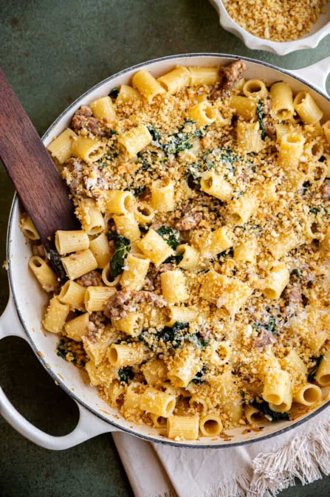 rigatoni with sausage and kale in a skillet.