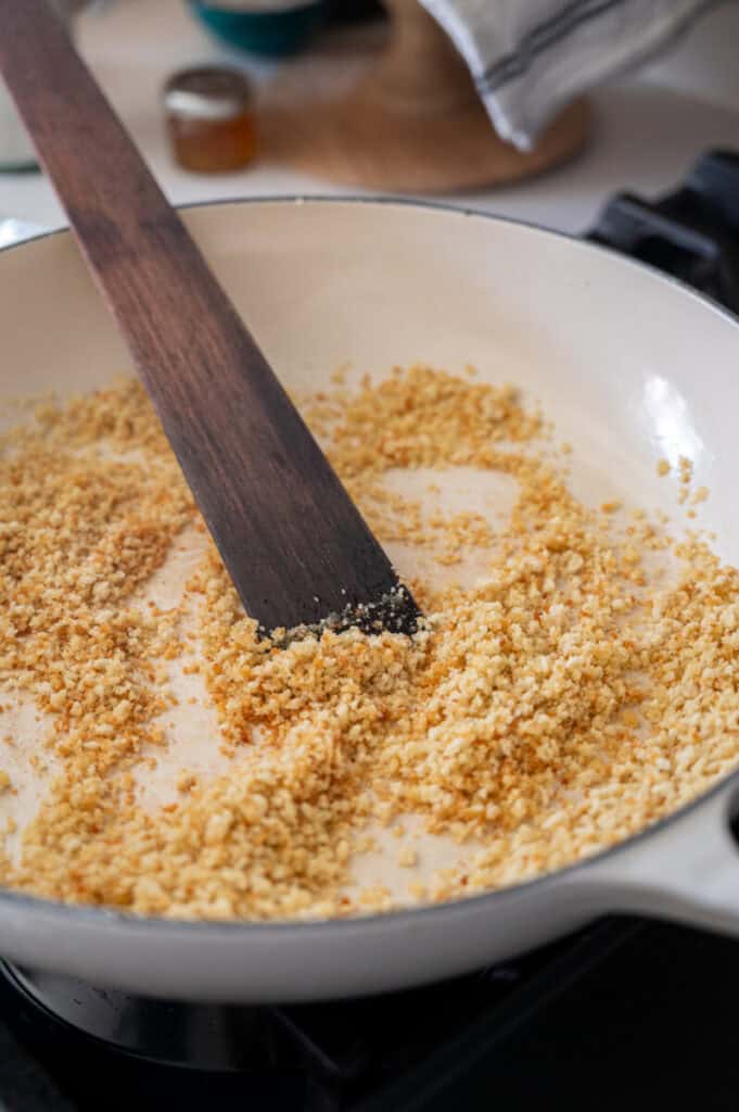 parmesan breadcrumbs toasting in a skillet.